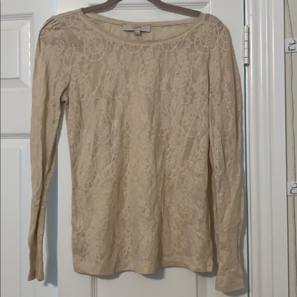 Long sleeved cream lace shirt.